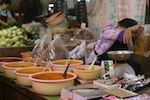 Woman sleeping while selling curry paste